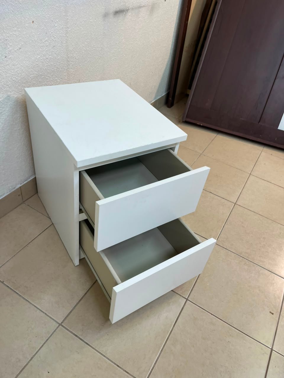 The IKEA MALM two-drawer chest of drawers in white is typically used as a bedside table or small storage unit. - Image 12