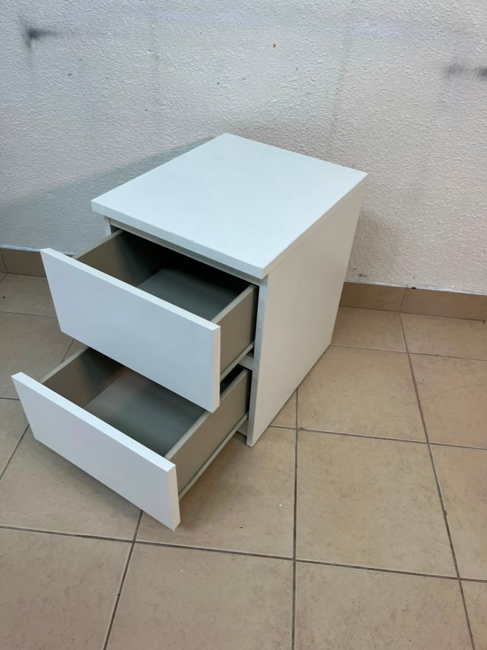 The IKEA MALM two-drawer chest of drawers in white is typically used as a bedside table or small storage unit. - Image 4