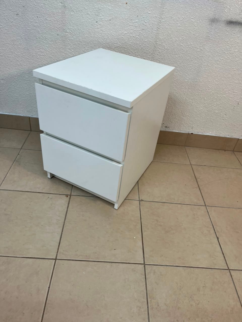 The IKEA MALM two-drawer chest of drawers in white is typically used as a bedside table or small storage unit.