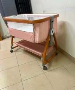 Portable Baby Bassinet / Co-Sleeper Crib with Lockable Wheels – Pink Fabric, Mesh Side Panels, Wood-Tone Frame & Under-Bed Storage Shelf - Image 5