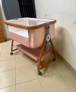 Portable Baby Bassinet / Co-Sleeper Crib with Lockable Wheels – Pink Fabric, Mesh Side Panels, Wood-Tone Frame & Under-Bed Storage Shelf - Image 7