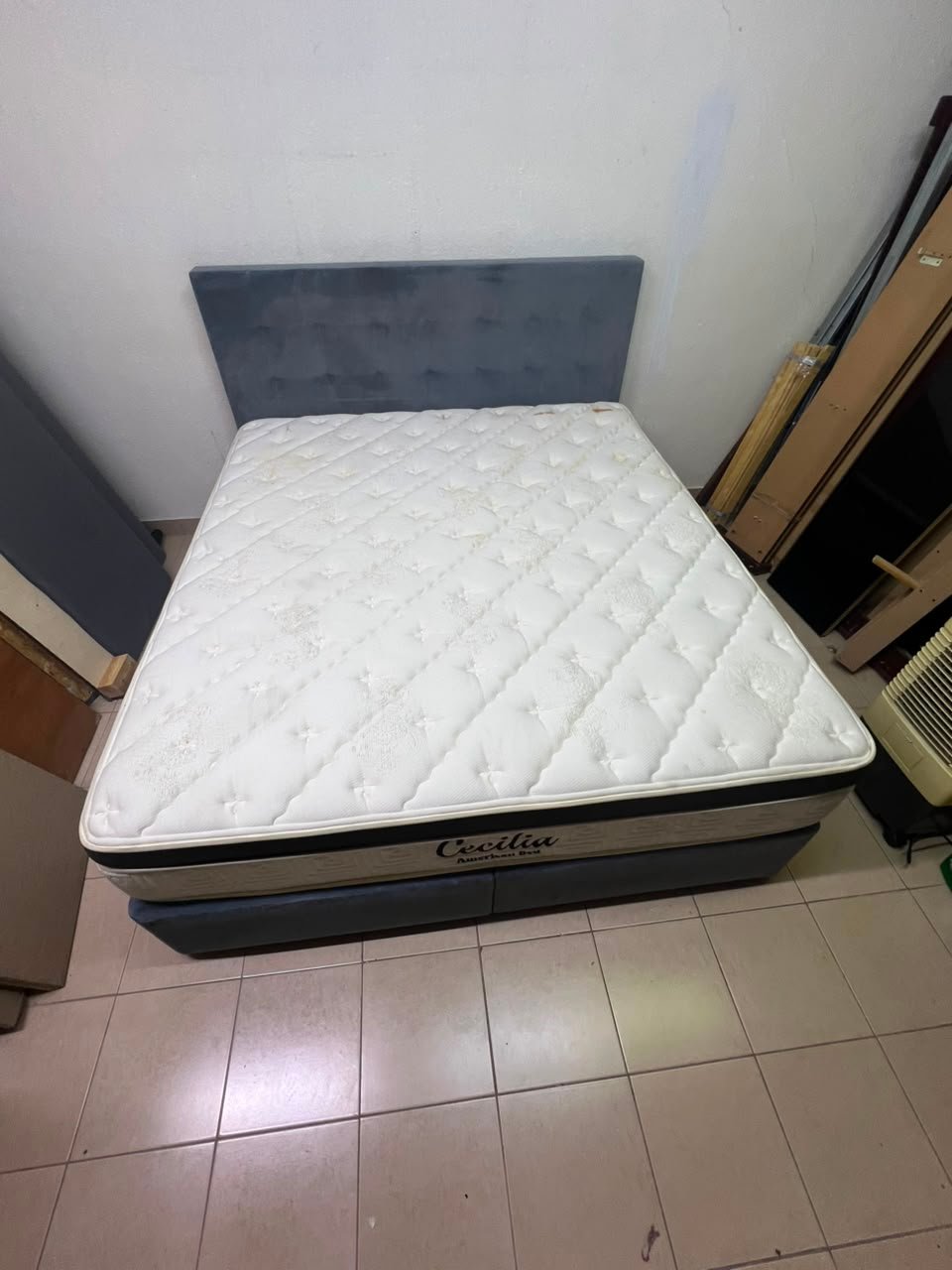 A modern, gray, upholstered double bed, paired with a thick, padded mattress with a soft top layer, featuring a prominent black border. - Image 2