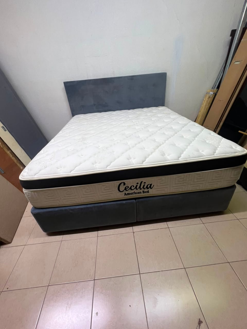 A modern, gray, upholstered double bed, paired with a thick, padded mattress with a soft top layer, featuring a prominent black border. - Image 4
