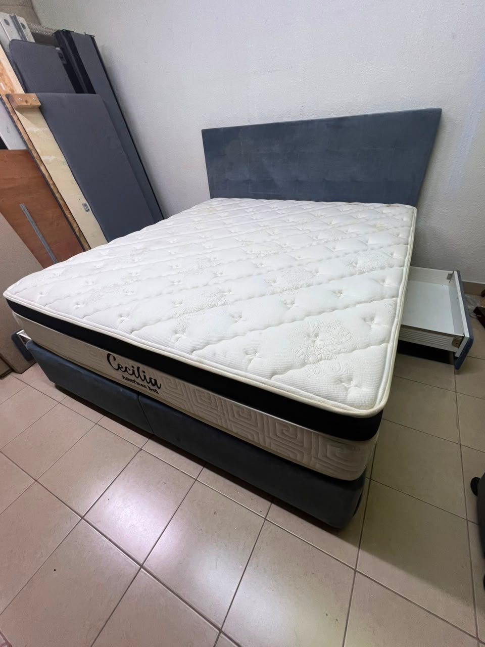 A modern, gray, upholstered double bed, paired with a thick, padded mattress with a soft top layer, featuring a prominent black border. - Image 5