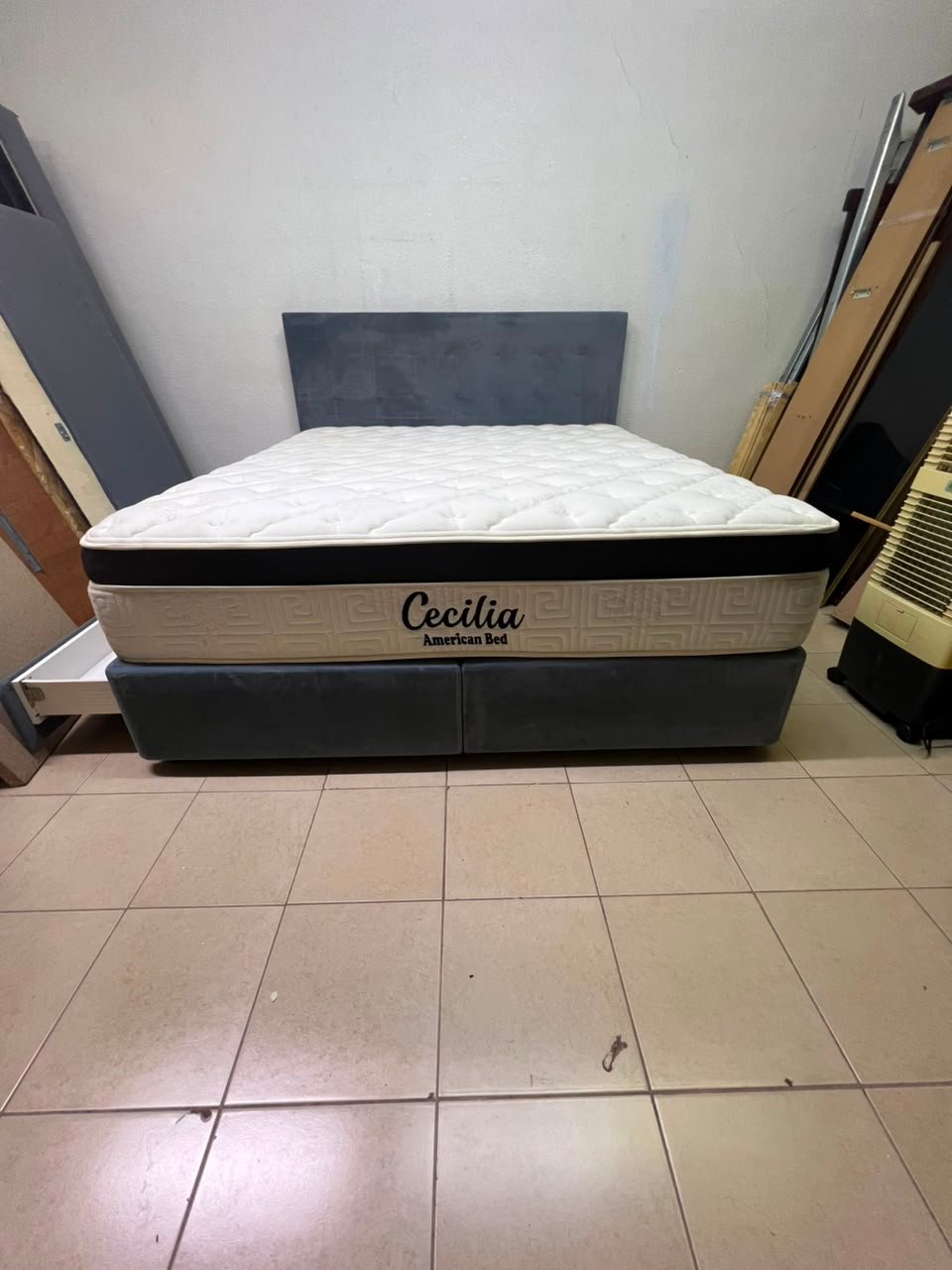 A modern, gray, upholstered double bed, paired with a thick, padded mattress with a soft top layer, featuring a prominent black border. - Image 7
