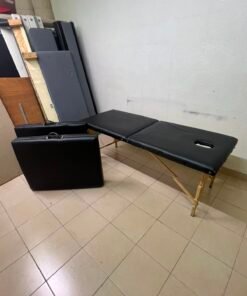 Portable and foldable massage tables made of black leather with a wooden frame and height-adjustable legs. - Image 2