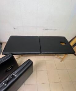 Portable and foldable massage tables made of black leather with a wooden frame and height-adjustable legs. - Image 3