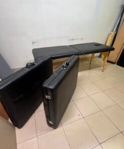 Portable and foldable massage tables made of black leather with a wooden frame and height-adjustable legs. - Image 5