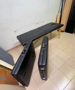 Portable and foldable massage tables made of black leather with a wooden frame and height-adjustable legs.