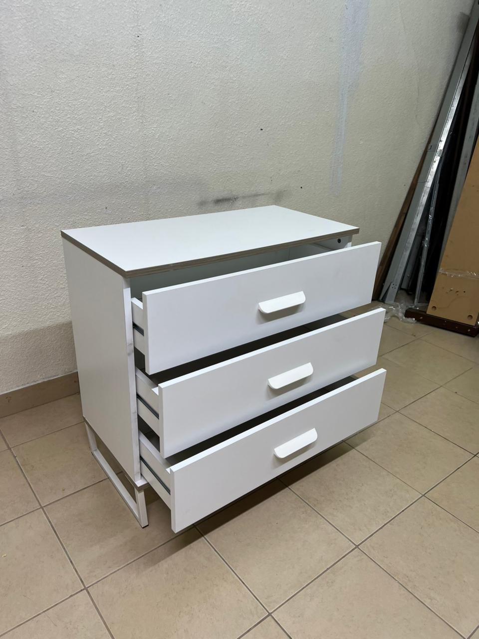 White chest of drawers with three drawers and metal legs with a connected frame. - Image 7