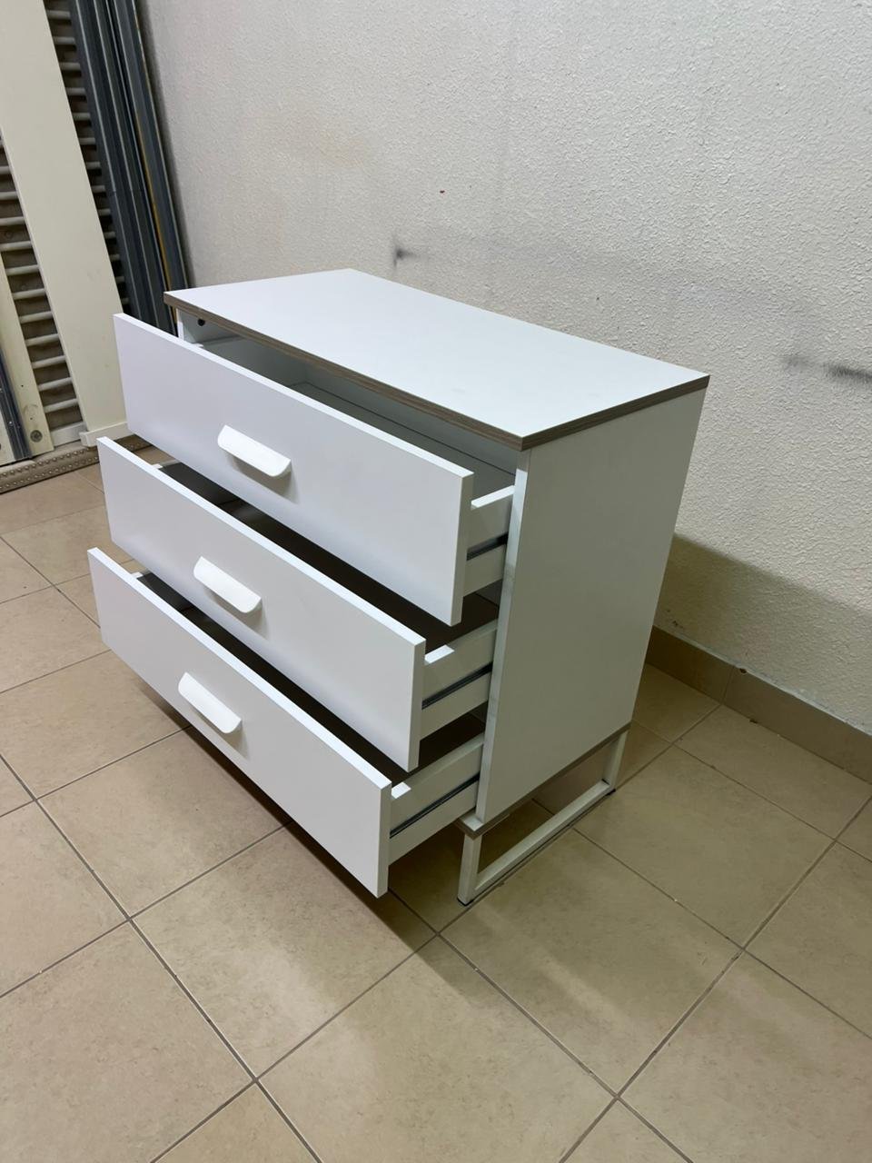 White chest of drawers with three drawers and metal legs with a connected frame. - Image 8