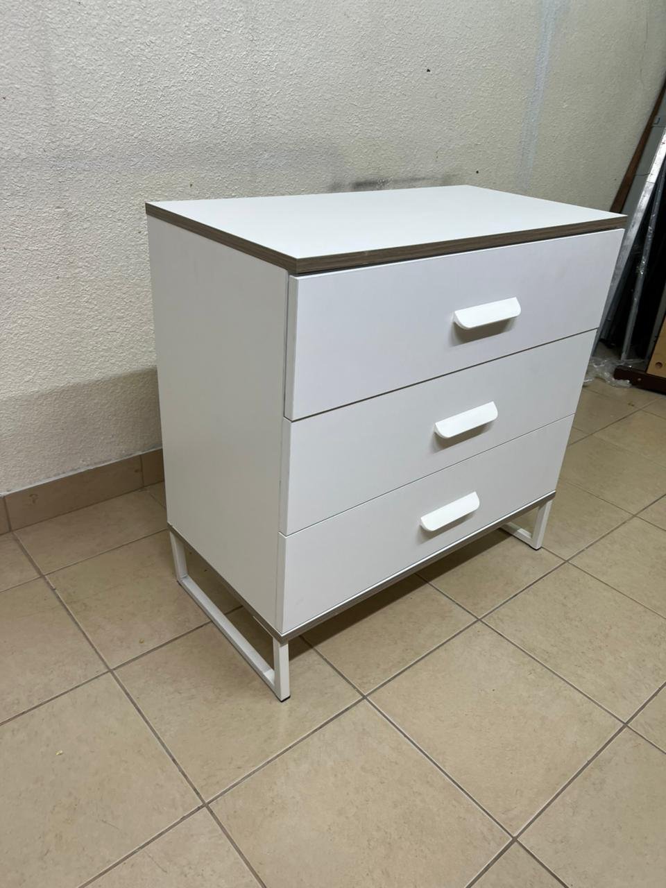 White chest of drawers with three drawers and metal legs with a connected frame. - Image 2