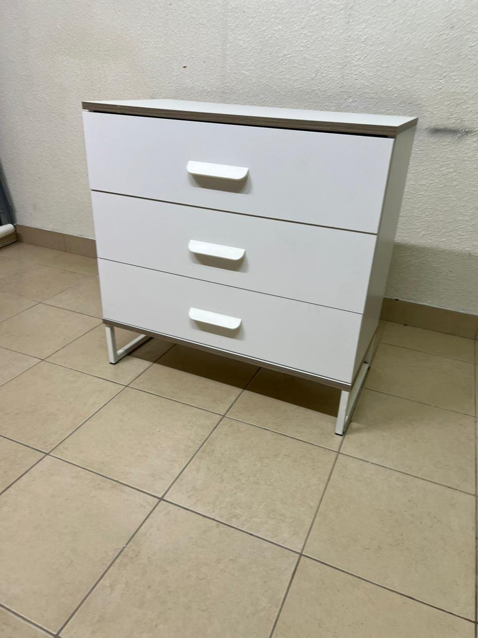 White chest of drawers with three drawers and metal legs with a connected frame. - Image 4
