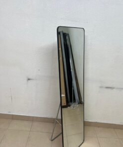 A tall, modern floor mirror featuring a slim black frame and elegant rounded corners.