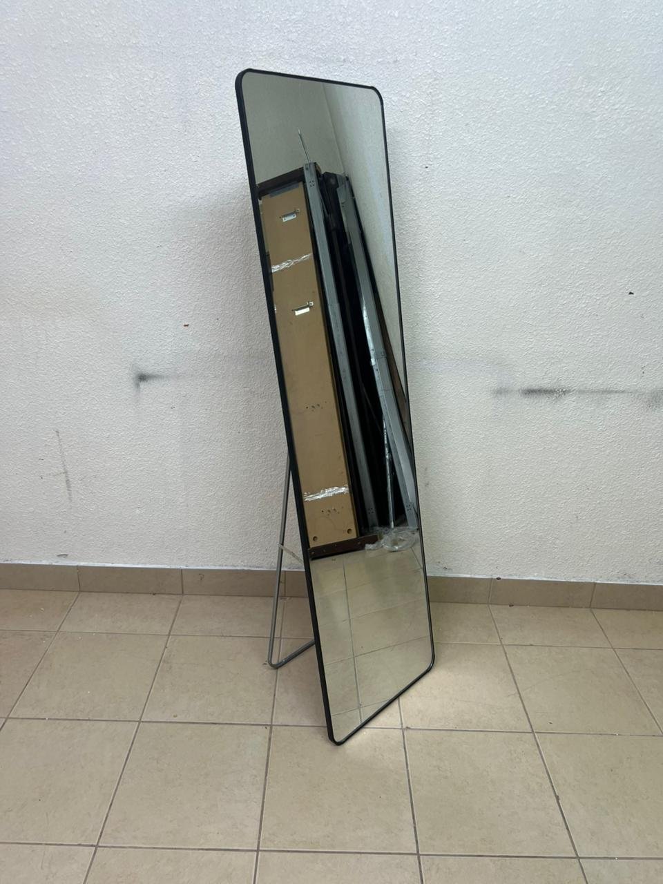 A tall, modern floor mirror featuring a slim black frame and elegant rounded corners. - Image 7