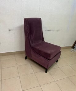 This is an armless side chair covered in warm purple velvet fabric with dark wooden legs.