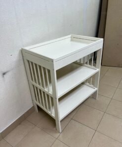 This GULLIVER table from IKEA comes in white and features practical storage shelves and a sturdy wooden design.