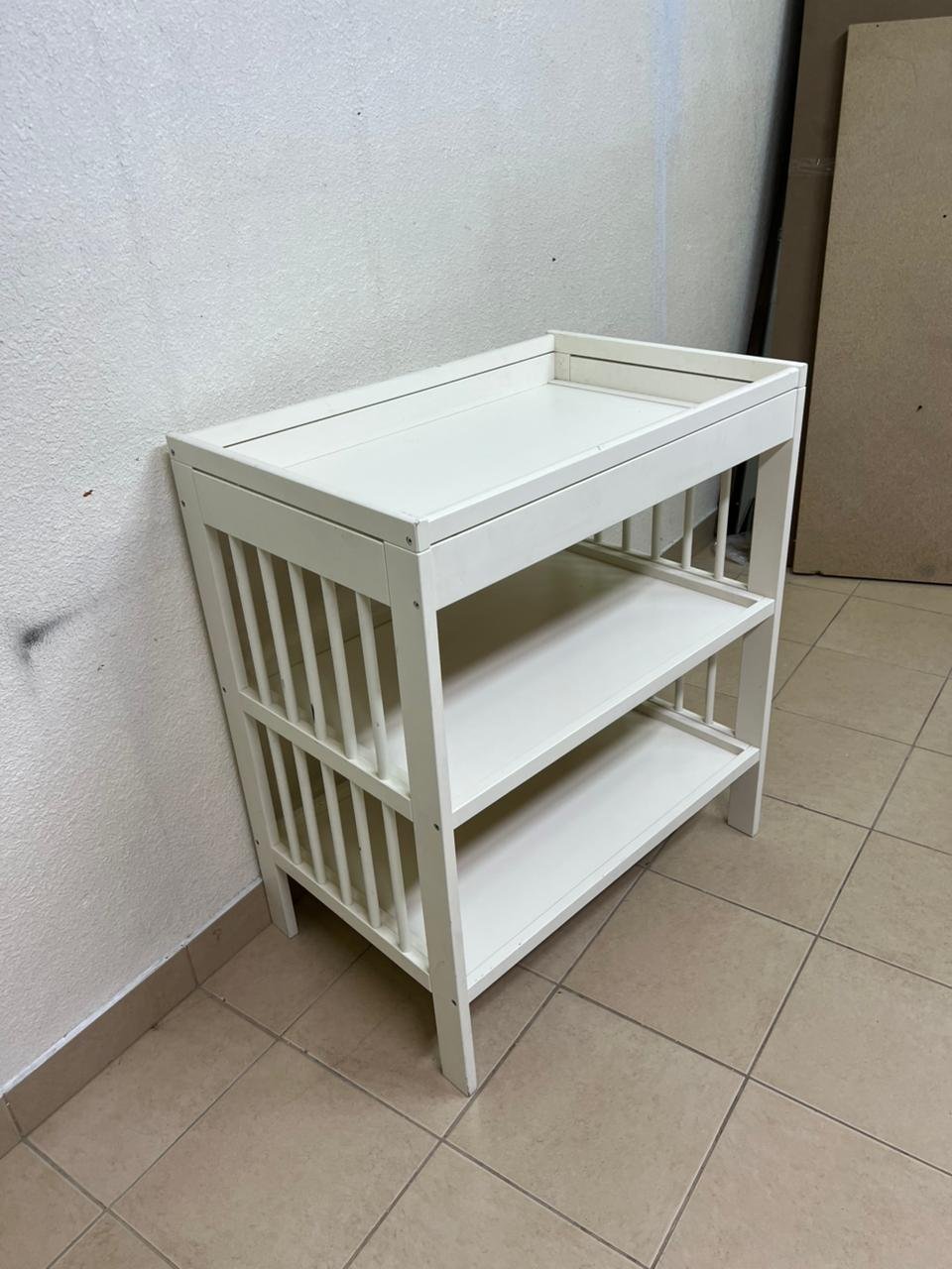 This GULLIVER table from IKEA comes in white and features practical storage shelves and a sturdy wooden design.