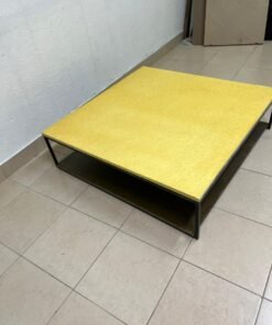 This is a square coffee table with an industrial design, featuring a black metal frame, a black pull-out drawer or lower shelf, and a light yellow wooden top. - Image 4
