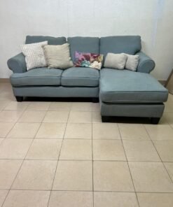 This is a light blue fabric corner sofa featuring a comfortable design with various cushions. - Image 2