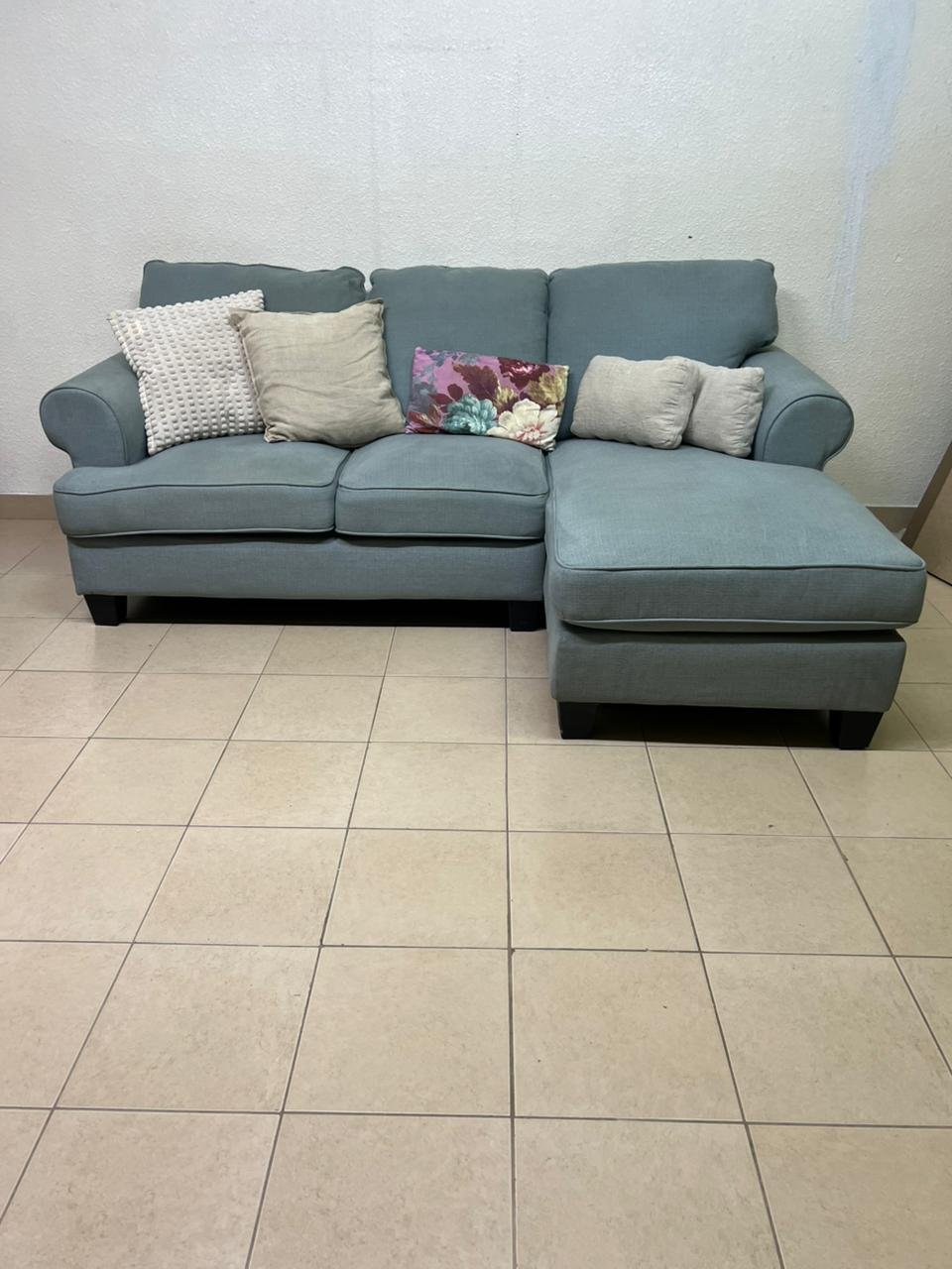 This is a light blue fabric corner sofa featuring a comfortable design with various cushions. - Image 2
