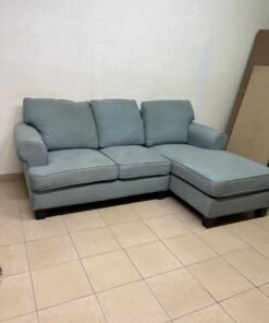 This is a light blue fabric corner sofa featuring a comfortable design with various cushions. - Image 3