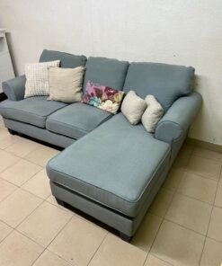 This is a light blue fabric corner sofa featuring a comfortable design with various cushions. - Image 4