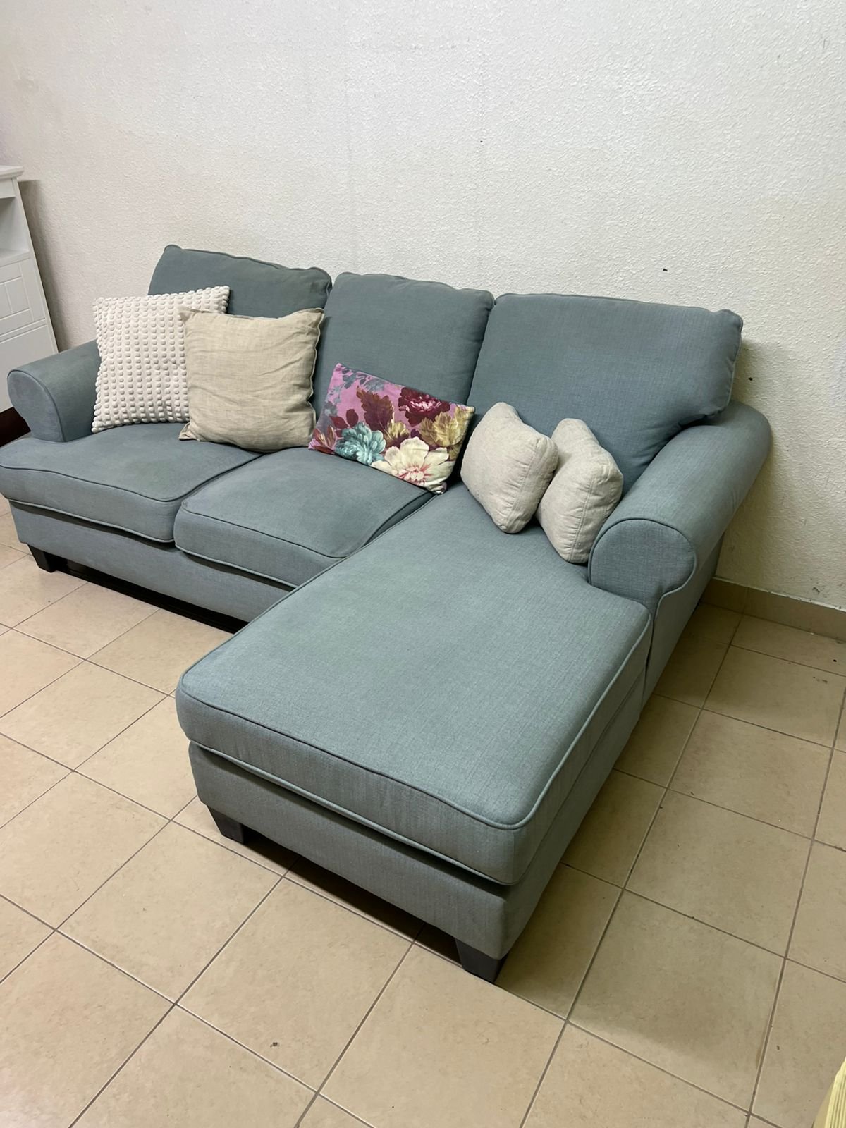 This is a light blue fabric corner sofa featuring a comfortable design with various cushions. - Image 4
