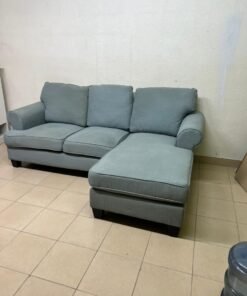 This is a light blue fabric corner sofa featuring a comfortable design with various cushions. - Image 6