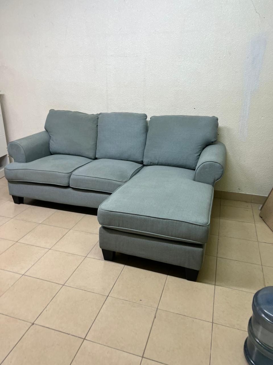 This is a light blue fabric corner sofa featuring a comfortable design with various cushions. - Image 6