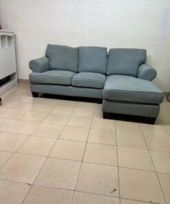 This is a light blue fabric corner sofa featuring a comfortable design with various cushions. - Image 7