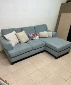 This is a light blue fabric corner sofa featuring a comfortable design with various cushions. - Image 8