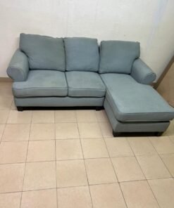 This is a light blue fabric corner sofa featuring a comfortable design with various cushions. - Image 9