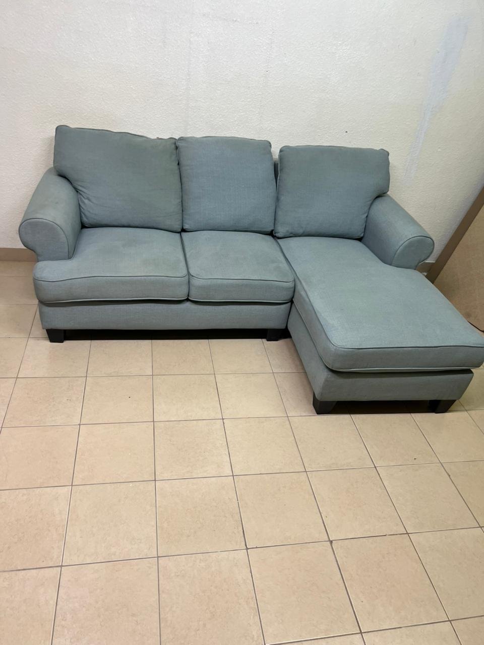 This is a light blue fabric corner sofa featuring a comfortable design with various cushions. - Image 9
