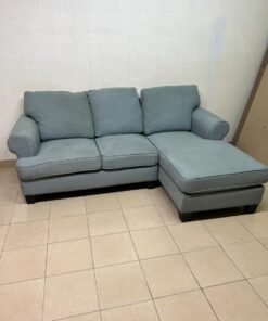 This is a light blue fabric corner sofa featuring a comfortable design with various cushions. - Image 13
