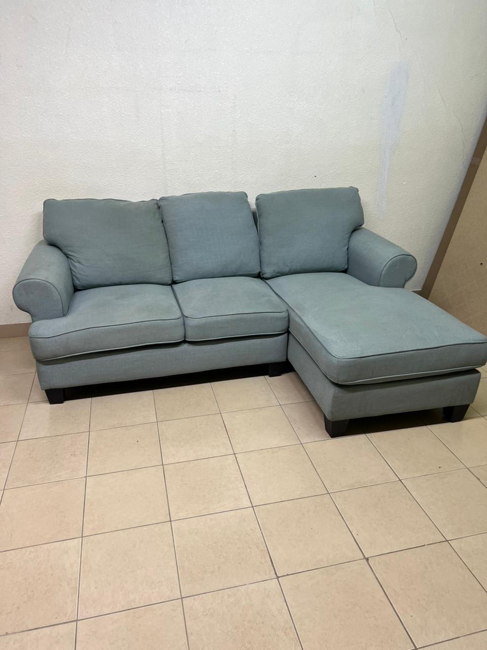This is a light blue fabric corner sofa featuring a comfortable design with various cushions. - Image 13