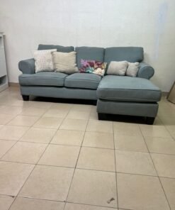 This is a light blue fabric corner sofa featuring a comfortable design with various cushions. - Image 12
