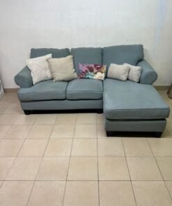 This is a light blue fabric corner sofa featuring a comfortable design with various cushions. - Image 14