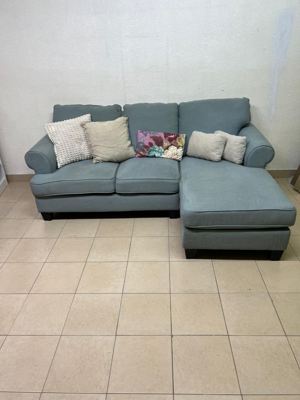 This is a light blue fabric corner sofa featuring a comfortable design with various cushions. - Image 14