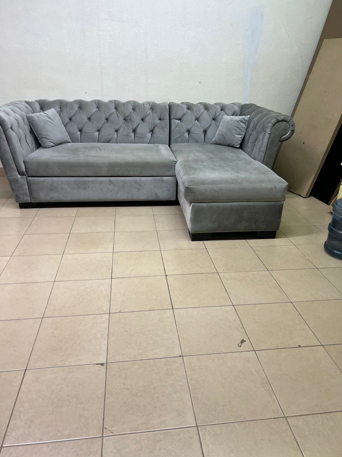 A stylish L-shaped gray sofa with internal storage space and a practical pull-out bed. - Image 5