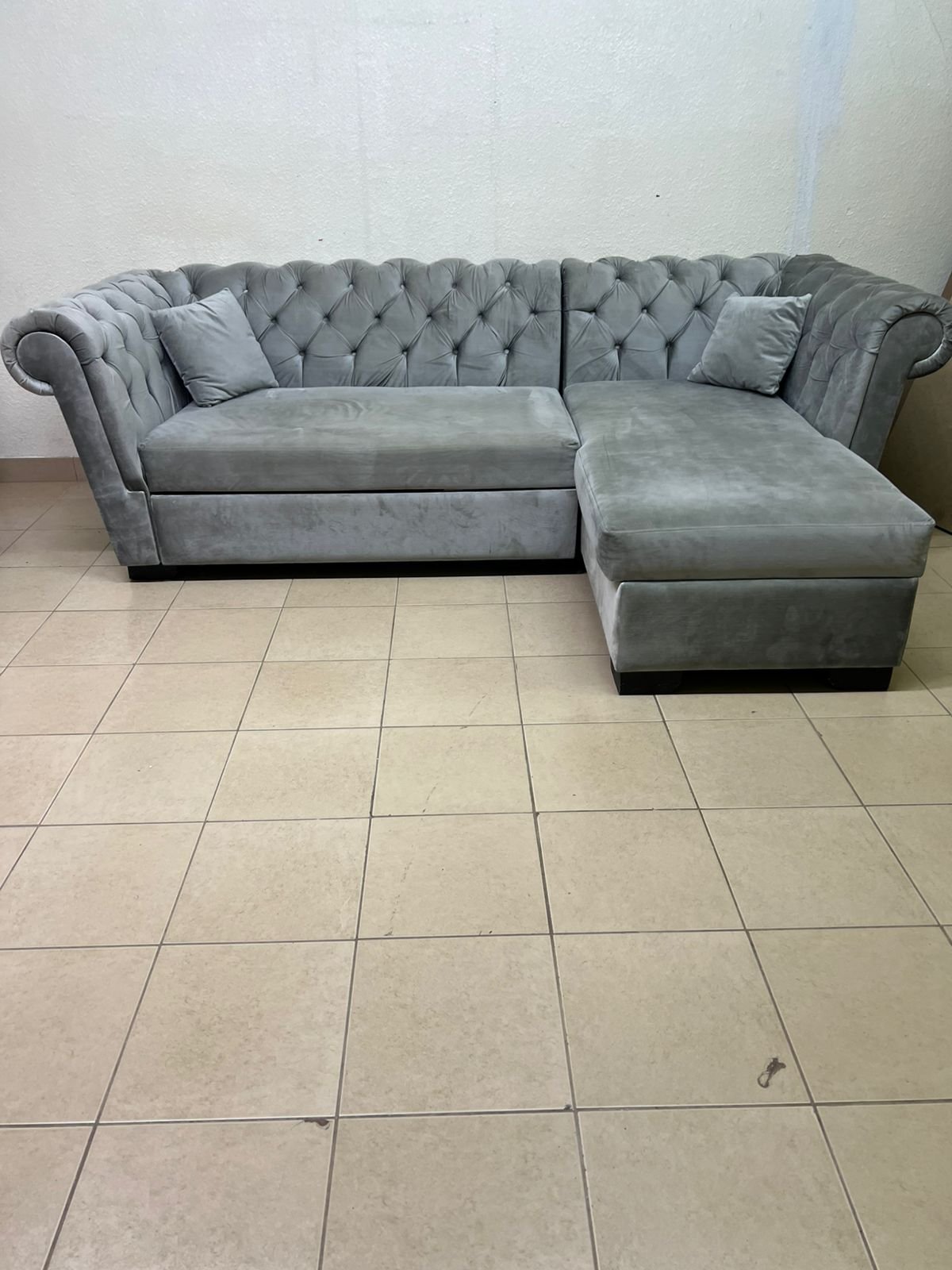 A stylish L-shaped gray sofa with internal storage space and a practical pull-out bed. - Image 6