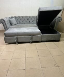 A stylish L-shaped gray sofa with internal storage space and a practical pull-out bed. - Image 3