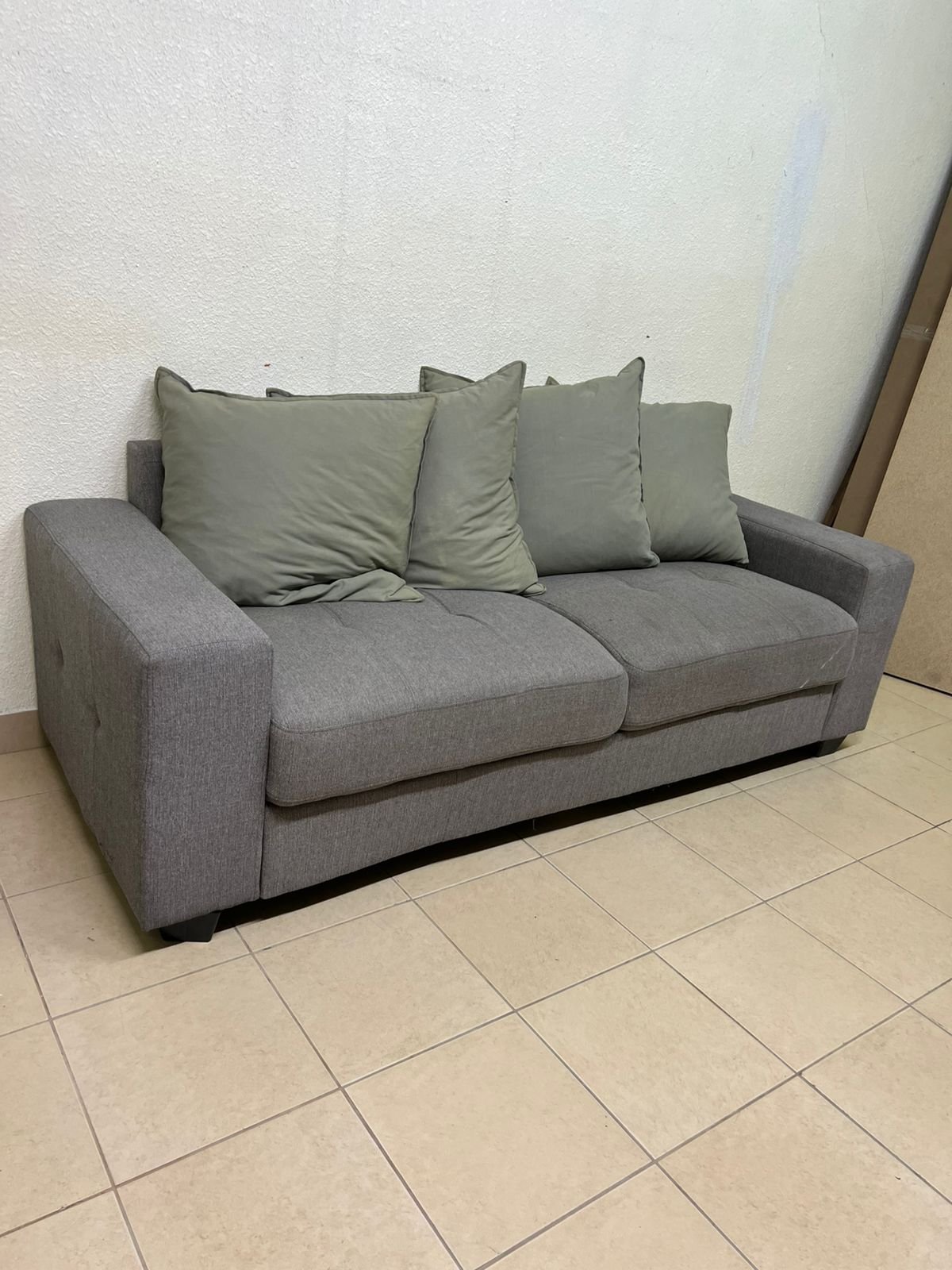A gray fabric sofa with three seats and a rectangular design, equipped with four olive green back cushions. - Image 3