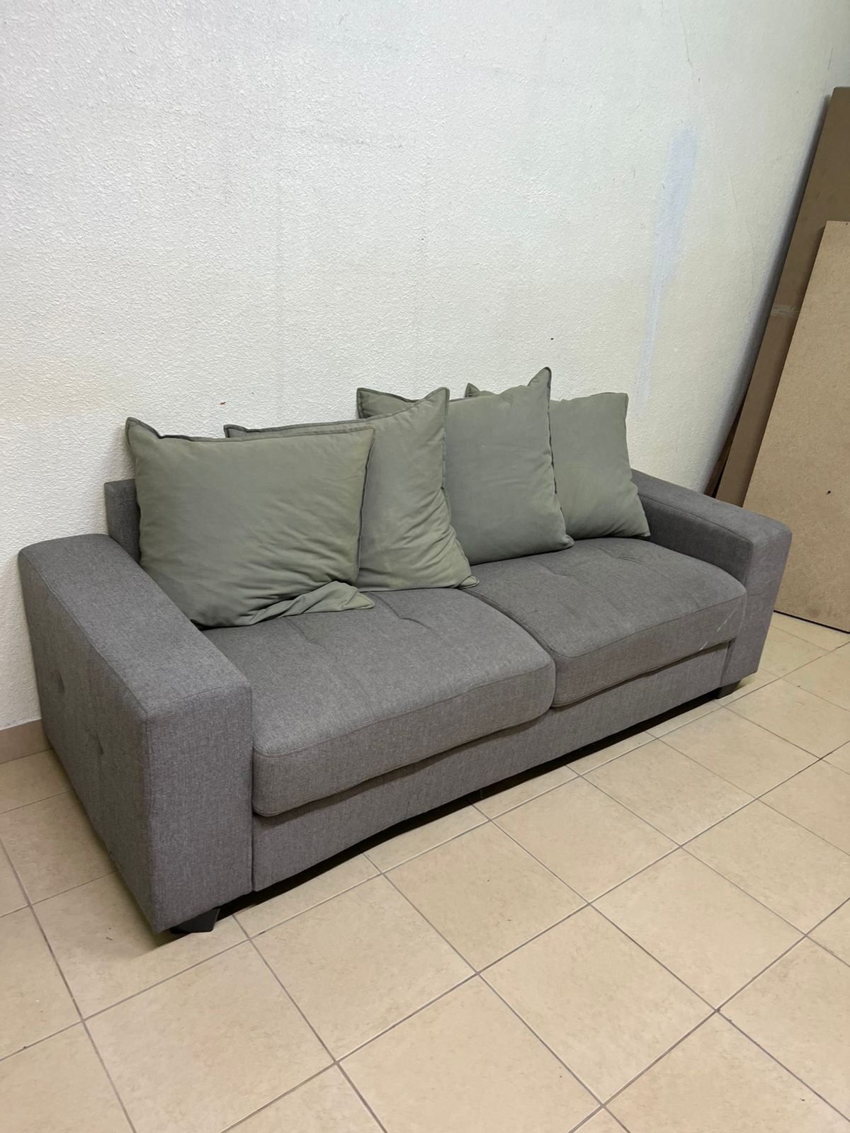 A gray fabric sofa with three seats and a rectangular design, equipped with four olive green back cushions. - Image 5