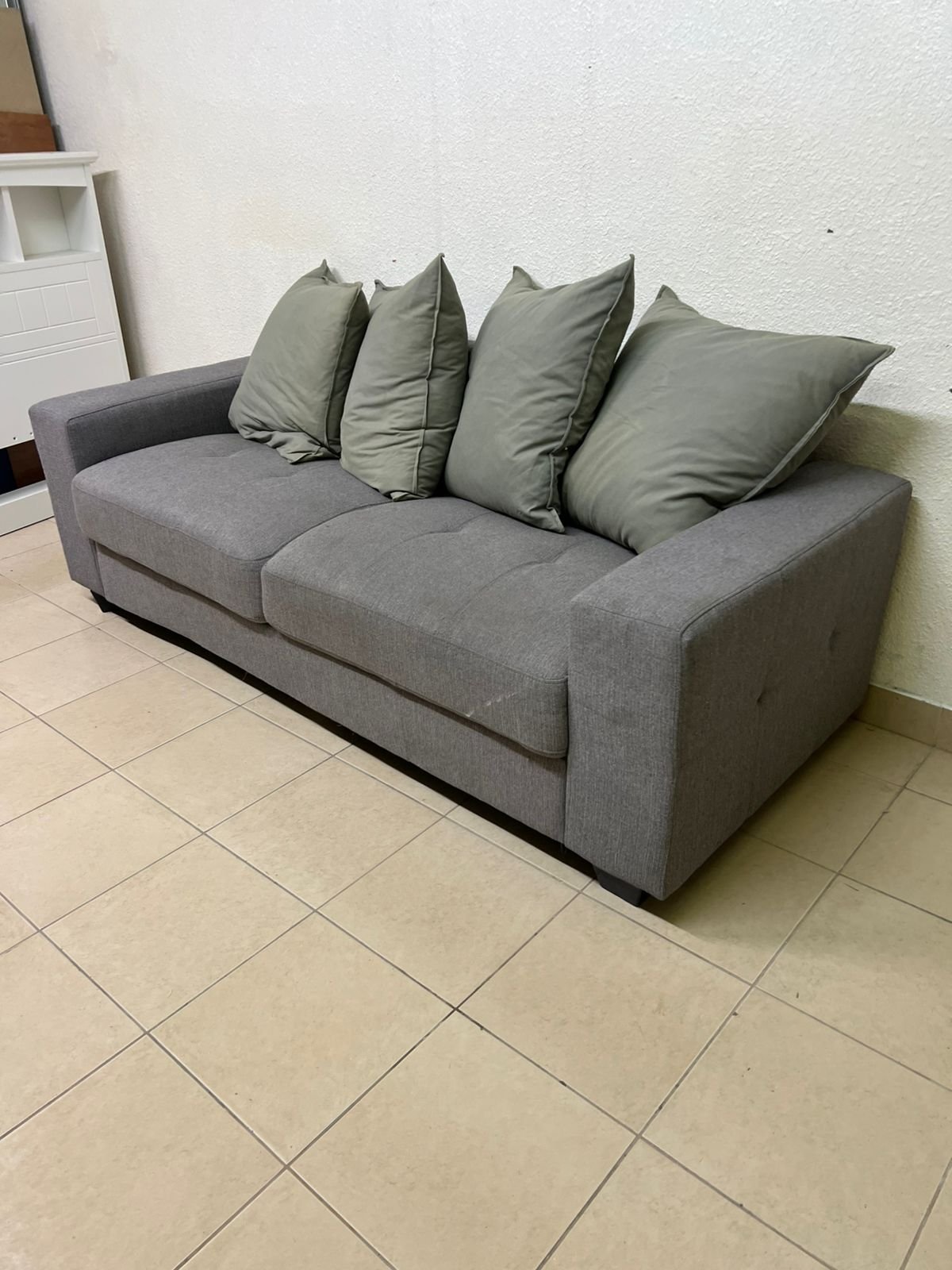 A gray fabric sofa with three seats and a rectangular design, equipped with four olive green back cushions. - Image 6