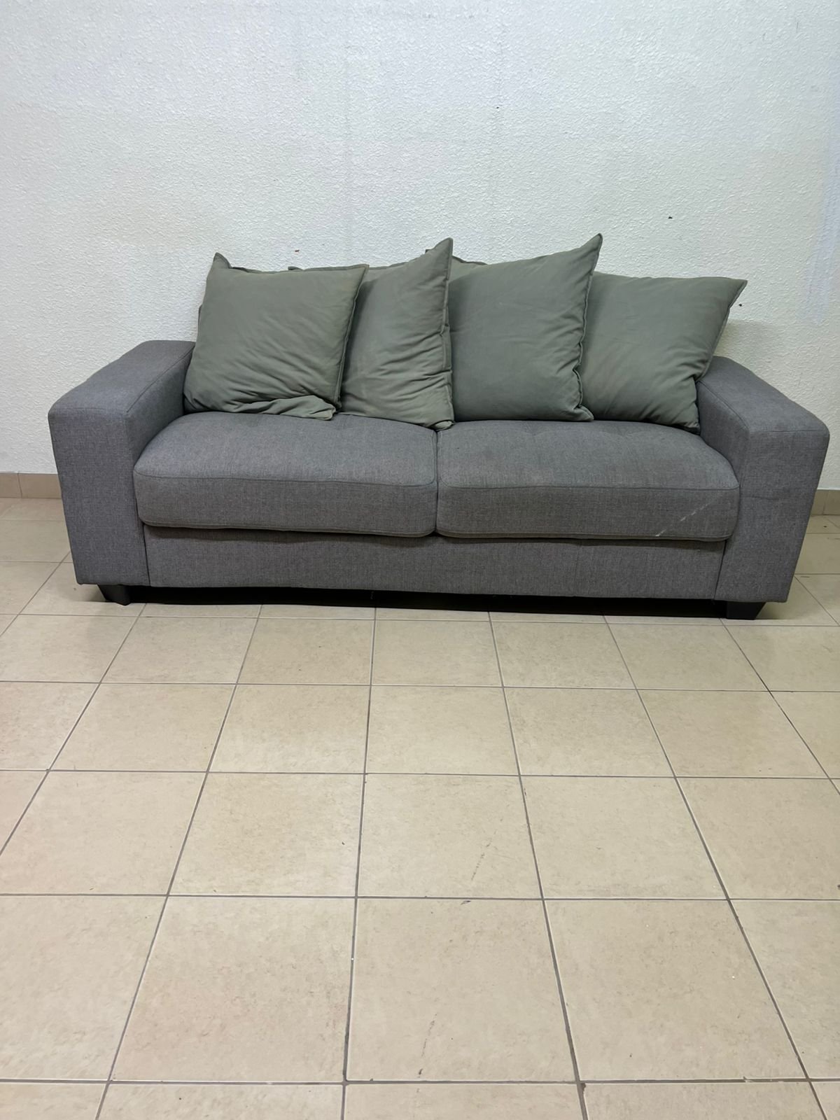 A gray fabric sofa with three seats and a rectangular design, equipped with four olive green back cushions. - Image 7