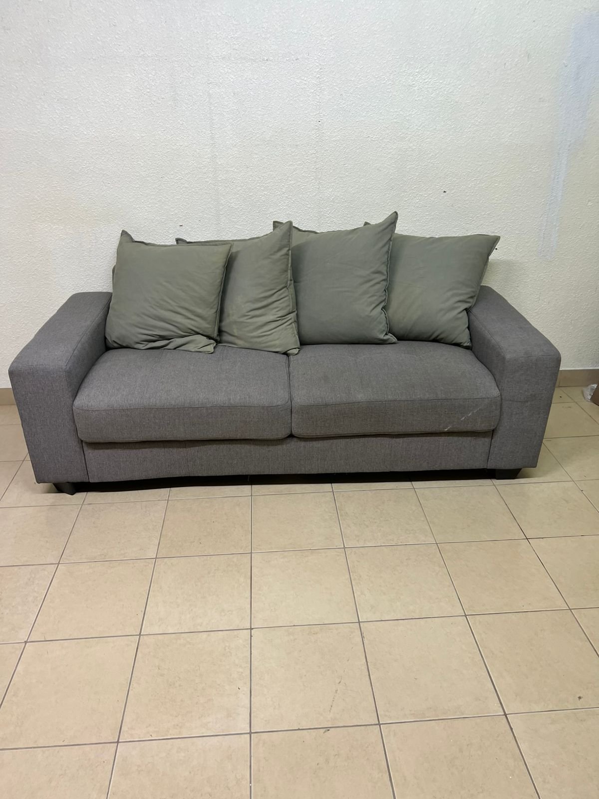 A gray fabric sofa with three seats and a rectangular design, equipped with four olive green back cushions. - Image 2