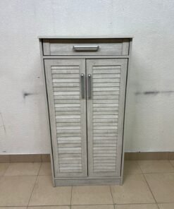 A wooden shoe cabinet (shoe rack) with a modern design in light gray or pale wood color, with two drawers or two doors with slides (slide doors) and a top handle for a small drawer.