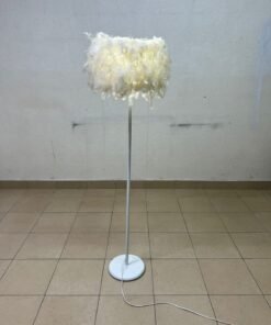 A modern floor lamp featuring a stylish cylindrical shade made of soft white feathers with a white metal base and pole. - Image 3