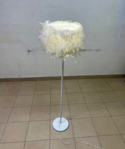 A modern floor lamp featuring a stylish cylindrical shade made of soft white feathers with a white metal base and pole.